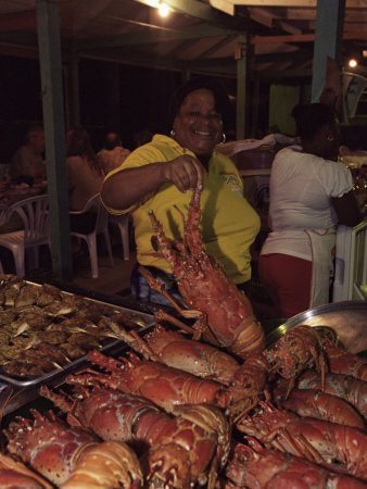 Local Woman Selling Lobsters At The Seafood Friday Night, Anse La Raye, St. Lucia, West Indies by Yadid Levy Pricing Limited Edition Print image
