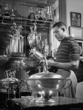 Joe Louis Standing In His Trophy Room In His House by Joe Scherschel Pricing Limited Edition Print image
