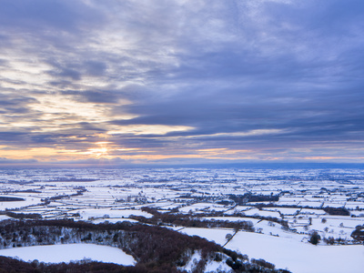 Sinking Sun And Stormy Clouds Over A Snow Covered Gormire Lake From Sutton Bank, Edge Of The North by Lizzie Shepherd Pricing Limited Edition Print image