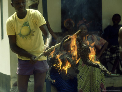 Burning Fur Off Monkey, West Africa by Robert Harvey Pricing Limited Edition Print image