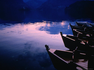 Gondolas Moored Along The Shore Of Lake Bled, Bled, Gorenjska, Slovenia by Jon Davison Pricing Limited Edition Print image