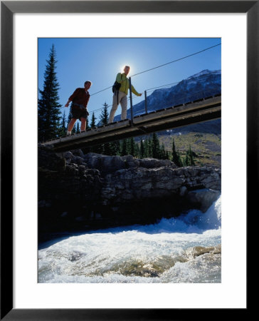 Hikers Crossing Bridge Over Fast-Flowing River, Yoho National Park, Canada by Philip & Karen Smith Pricing Limited Edition Print image