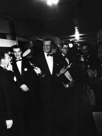 John Wayne Holding Oscar Awards For Absent Actor Gary Cooper And Dir. John Ford For High Noon by Loomis Dean Pricing Limited Edition Print image