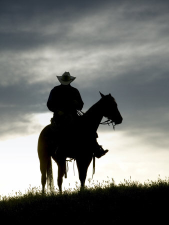 Cowboy On Horse In Silhouette On The Ridge Of A Mountain by Scott Stulberg Pricing Limited Edition Print image