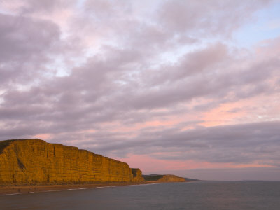 Towering Sandstone Cliffs At West Bay On The Jurassic Coast, Dorset, England, Uk by Adam Burton Pricing Limited Edition Print image