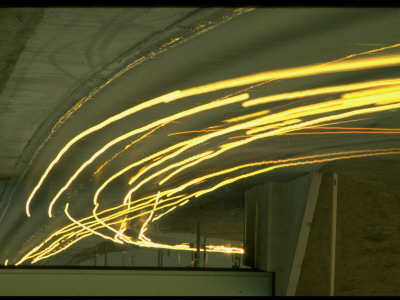 Streaking Car Lights In Lines Of White, Straight And Curving Off On Exit, At Night On Highway by Ralph Crane Pricing Limited Edition Print image