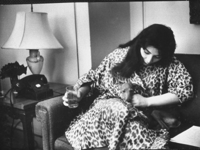 Singer Juliette Greco Holding Her Pet Whippet; Sitting On Sofa In Her Nyc Apartment by Gjon Mili Pricing Limited Edition Print image