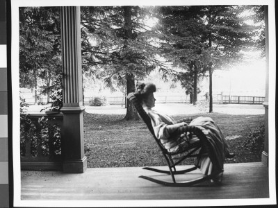 Mrs. Franklin S. Brady Sitting In A Wicker Rocking Chair On The Porch Of Her Home by Wallace G. Levison Pricing Limited Edition Print image