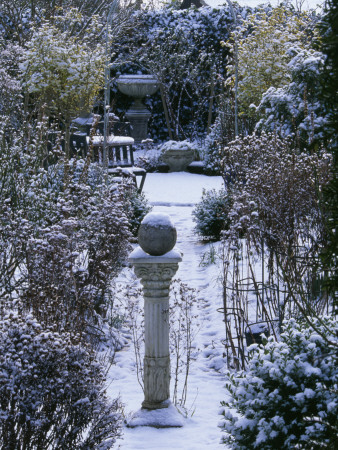 Winter At Woodchippings, Northamptonshire, December: View To Arch Along Path With Sundial In Snow by Clive Nichols Pricing Limited Edition Print image