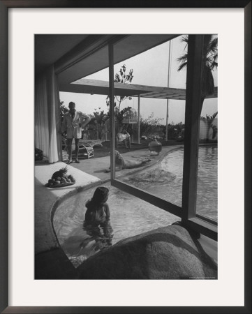Designer Raymond Loewy Relaxing By Swimming Pool Which Runs From Outdoors Into Living Room by Peter Stackpole Pricing Limited Edition Print image