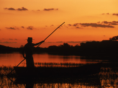 Gaucho Poling Canoe At Sunset, Ibera Marshes National Reserve, Argentina, South America by Ross Couper-Johnston Pricing Limited Edition Print image