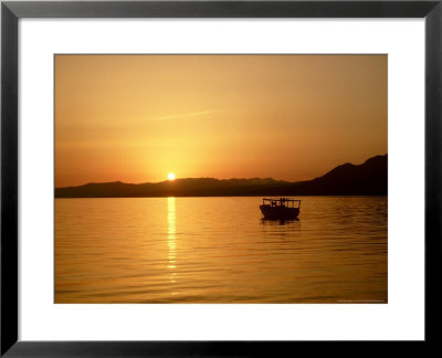 Boat In St. Thomass Bay At Pefkos At Sunset, Greece by Ian West Pricing Limited Edition Print image