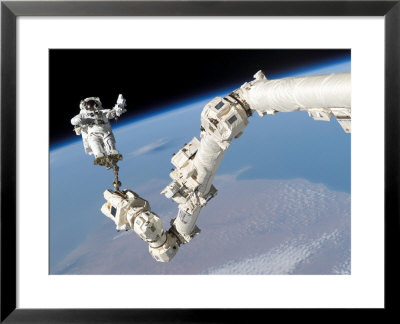 Astronaut Anchored To A Foot Restraint On The International Space Station's Canadarm2 by Stocktrek Images Pricing Limited Edition Print image