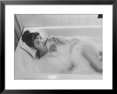 Unexposed Nude Woman In The Bathtub Amid The Bubbles While Smoking A Cigarette by Peter Stackpole Pricing Limited Edition Print image