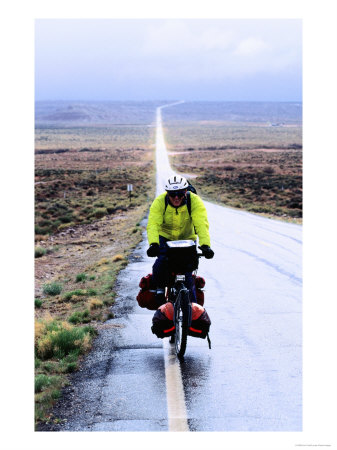 Cross-Country Cyclist On Wet Road, Monument Valley, U.S.A. by Ann Cecil Pricing Limited Edition Print image
