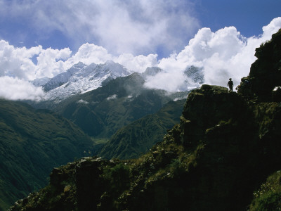 A Man Dwarfed By Massive Mountain Peaks In The Vilcabamba Range by Gordon Wiltsie Pricing Limited Edition Print image