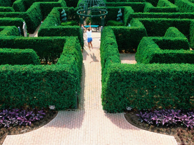 Girl Jumping In Maze At Missouri Botanical Garden, St. Louis, Missouri by Eddie Brady Pricing Limited Edition Print image