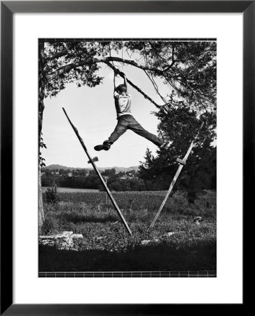 Kenneth Merriman Swinging On Tree Limb After Kicking Away Stilts by Robert W. Kelley Pricing Limited Edition Print image