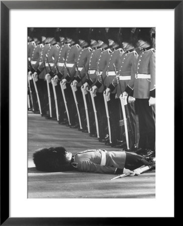 Member Of Honor Guard Lying On The Ground After Fainting During Ceremonies For Queen Elizabeth by John Loengard Pricing Limited Edition Print image