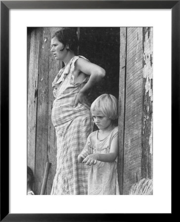 Pregnant Sharecropper's Wife Standing In Doorway Of Wooden Shack With Daughter, The Depression by Arthur Rothstein Pricing Limited Edition Print image