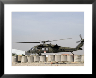 Uh-60 Blackhawk Prepares To Land At Camp Warhorse To Refuel by Stocktrek Images Pricing Limited Edition Print image