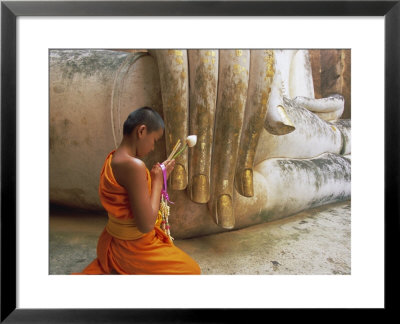 Novice Buddhist Monk And Phra Atchana Buddha Statue, Sukhothai Province, Thailand by Gavin Hellier Pricing Limited Edition Print image