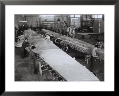 Workers On The Wing Of An Airplane In The Caproni Factory In Predappio by A. Villani Pricing Limited Edition Print image