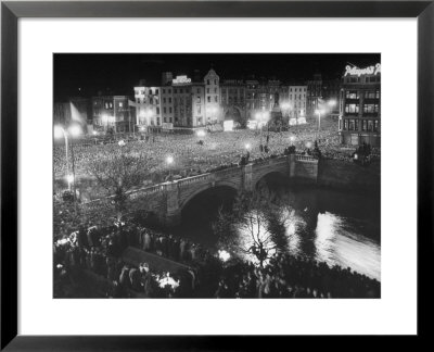 People Celebrating The Independence Of Ireland On O'connell Bridge Before Midnight On Easter Sunday by Larry Burrows Pricing Limited Edition Print image