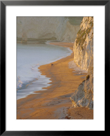 Couple Walking On Beach. Isle Of Purbeck, Dorset, England Uk by Jean Brooks Pricing Limited Edition Print image