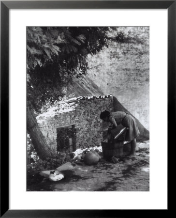 Washerwoman Cleaning Fabric In Wooden Tub by A. Villani Pricing Limited Edition Print image
