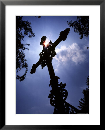 Sunlight Shines On An Iron Crucifix Marking A Grave by Rex Stucky Pricing Limited Edition Print image