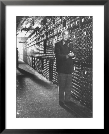 Baron Philippe De Rothschild In A Wine Cellar At Chateau Mouton Rothschild by Carlo Bavagnoli Pricing Limited Edition Print image