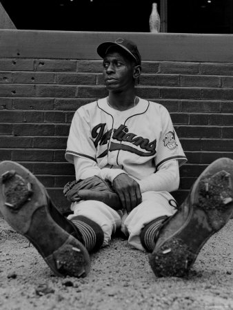Baseball Player Satchel Paige Sitting Alone On The Ground, Resting His Sore Feet by George Silk Pricing Limited Edition Print image