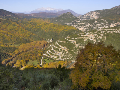 Looking Down Onto The Hairpin Bends As The Road Winds Up The Hill Towards The Papingo (Papigo) Vill by Lizzie Shepherd Pricing Limited Edition Print image