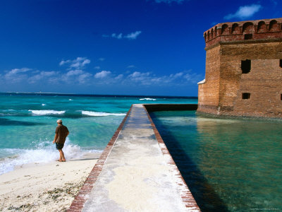 Tourist Near Moat Wall Of Fort Jefferson, Garden Key by Eddie Brady Pricing Limited Edition Print image