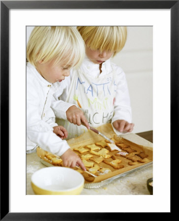 Two Children Brushing Biscuits With Glace Icing by Renate Forster Pricing Limited Edition Print image