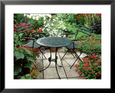 Metal Table And Chairs On Patio Backed By Pots With Lilium Longifolium by Lynne Brotchie Pricing Limited Edition Print image