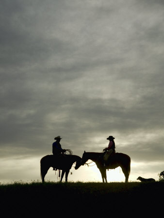 Cowboy And Cowgirl On Horseback In Silhouette At Sunset by Scott Stulberg Pricing Limited Edition Print image