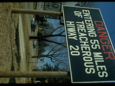 Sign Danger Entering 55 Miles Of Treacherous Highway 20 At Edge Of Highway. Western Illinois by Ralph Crane Pricing Limited Edition Print image