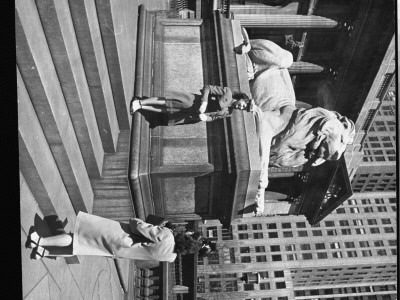 Young Woman Posing For Picture By Stone Lion In Front Of New York Public Library by Alfred Eisenstaedt Pricing Limited Edition Print image