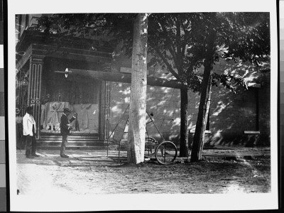 Two Men Standing Near A Street Telescope That Is Osbc. From View by Wallace G. Levison Pricing Limited Edition Print image