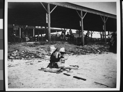 Two Young Girls At Brighton Beach With Hats On by Wallace G. Levison Pricing Limited Edition Print image