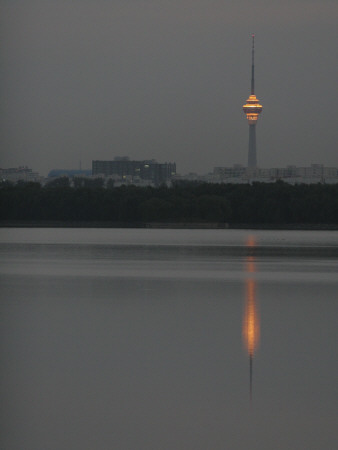 Lights On The China Central Tv Tower In Beijing Reflect In A Lake At The Summer Palace by Ben Mcmillan Pricing Limited Edition Print image