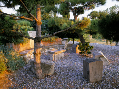 La Chabaude, France, Stone And Wood Seating Area, Gravel Terrace, Pine Tree, Designer Scott Stover by Clive Nichols Pricing Limited Edition Print image