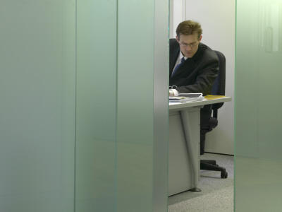 Office Life And Interiors, Businessman Working At Desk by Richard Bryant Pricing Limited Edition Print image