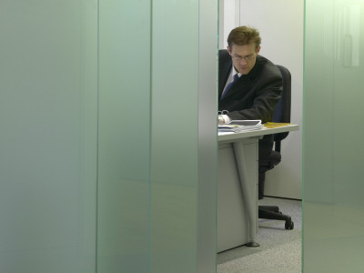 Office Life And Interiors, Businessman Working At Desk by Richard Bryant Pricing Limited Edition Print image