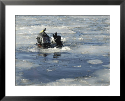 Us Navy Diver Signals He Is Okay During A Training Mission In The Icy Thames River by Stocktrek Images Pricing Limited Edition Print image