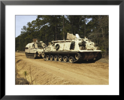An M-88 Recovery Vehicle Begins To Tow An M992 Field Artillery Ammunition Supply Vehicle by Stocktrek Images Pricing Limited Edition Print image