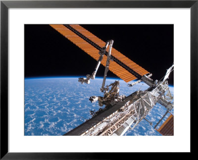 The Canadarm2 And Solar Array Panel Wings On The International Space Station, August 11, 2007 by Stocktrek Images Pricing Limited Edition Print image
