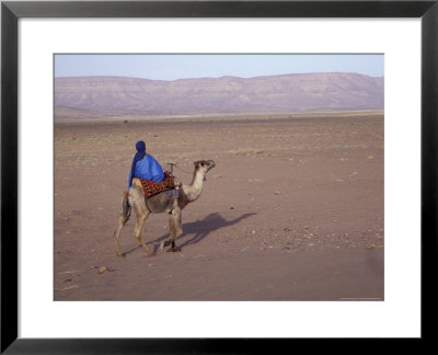 Man In Traditional Dress Riding Camel, Morocco by John & Lisa Merrill Pricing Limited Edition Print image